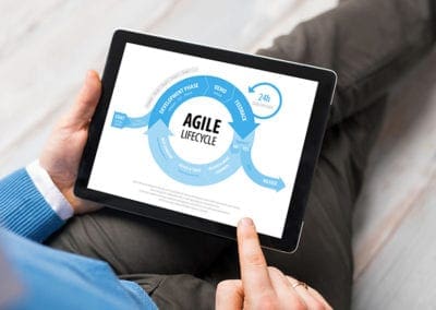 Man holding laptop with Agile