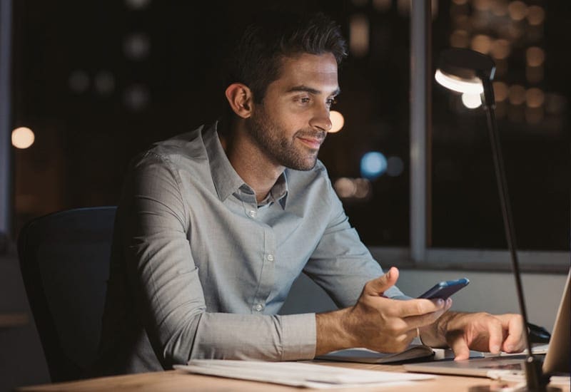 businessman working on laptop with phone 24 7  full-service  IT support