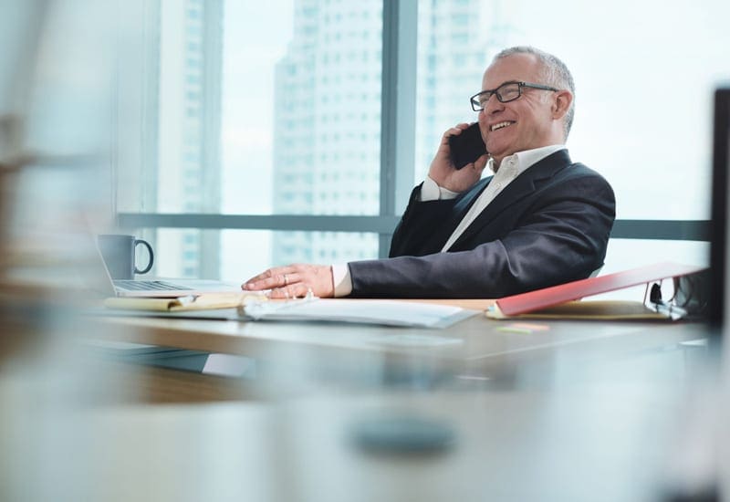 Relaxed businessman on phone with Managed IT Services