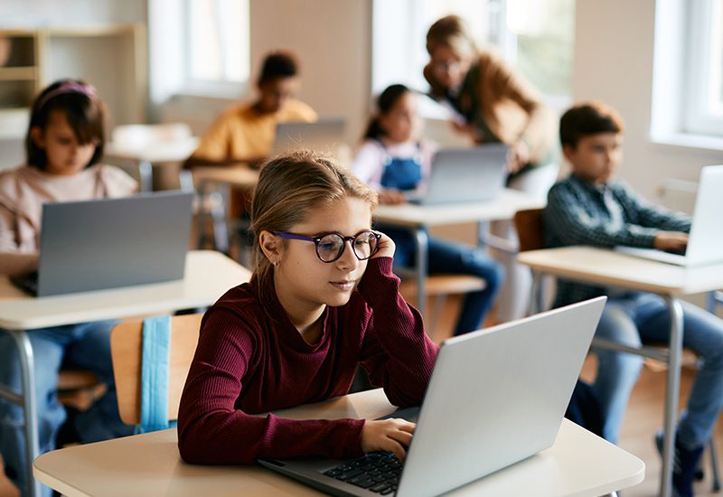 Managed Service Agreements in Education Student Sitting at Desk in Classroom