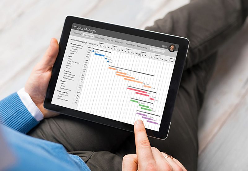 Project planning with man holding tablet with gantt chart